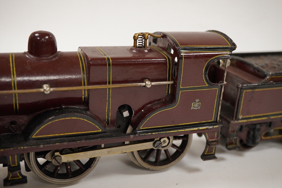 An 0 gauge Bing clockwork tinplate Midland Railway 4-4-0 tender locomotive, 999, in maroon livery with yellow and black lining and original clockwork mechanism